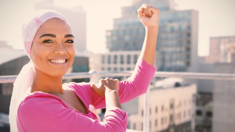 woman wit hcancer wearing pink head scarf