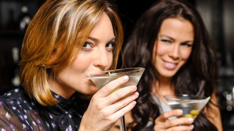 two women drinking martinis