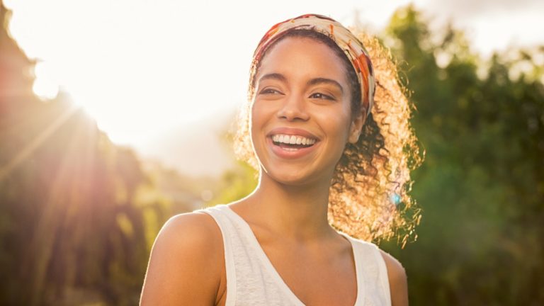 african american woman wearing white tank top and orange headband