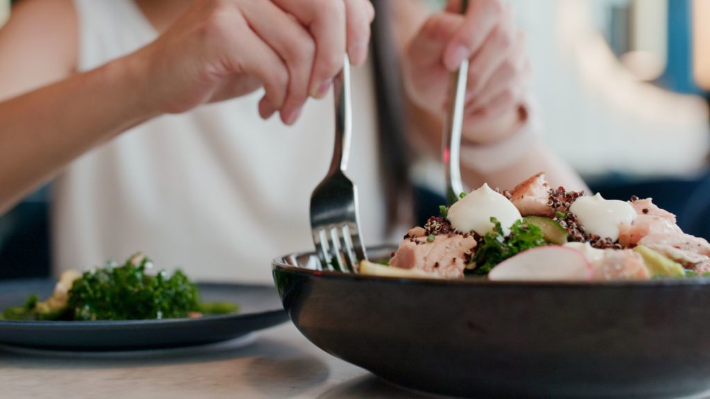 woman eating salad at a restaurant