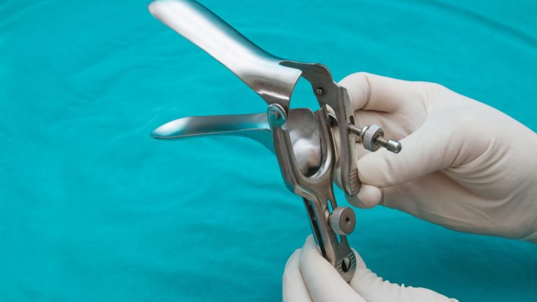 doctor holding speculum