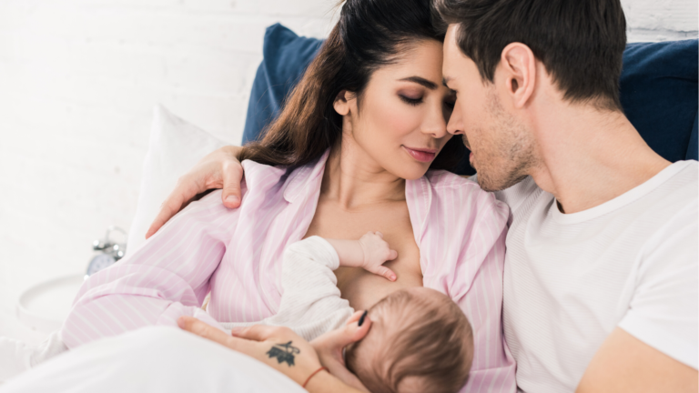mother and father hlding breastfeeding baby