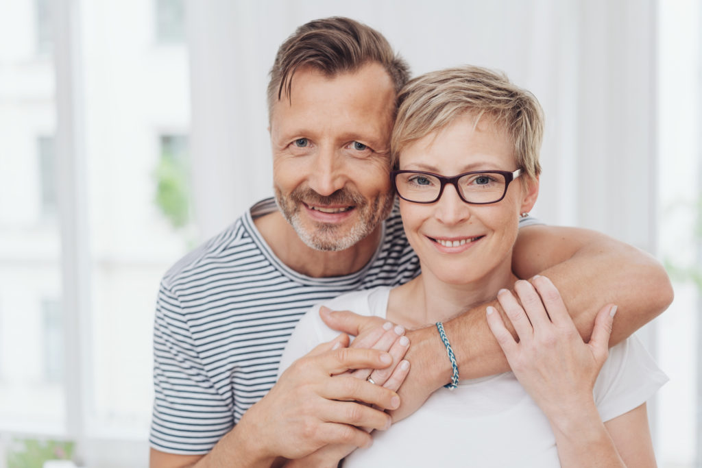 older couple with arms wrapped around each other