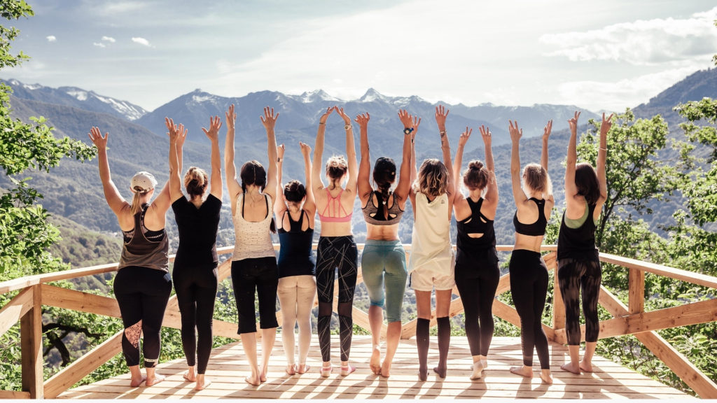 group of women with their hands raised turned away from the camera