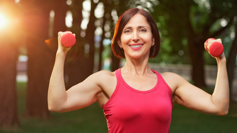 middle aged woman holding weights
