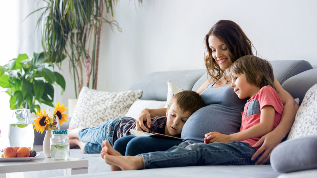 pregnant woman with her two small children