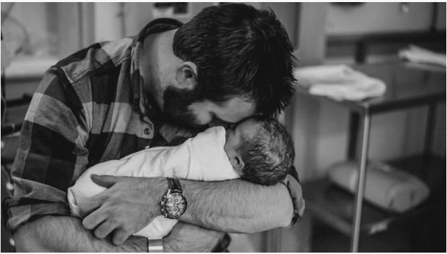 father holding baby