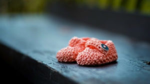 pink crocheted baby shoes