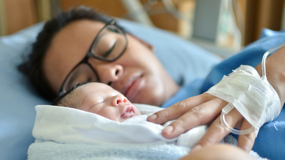 woman holding her newborn baby