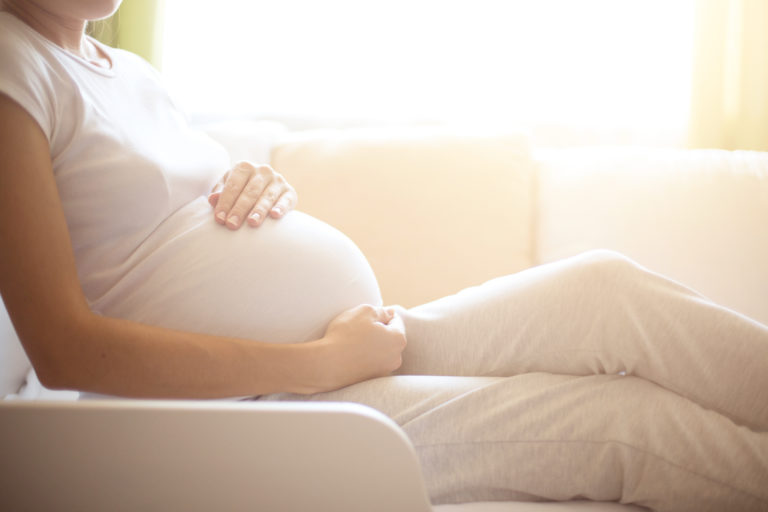 pregnant woman sitting in lounge chair